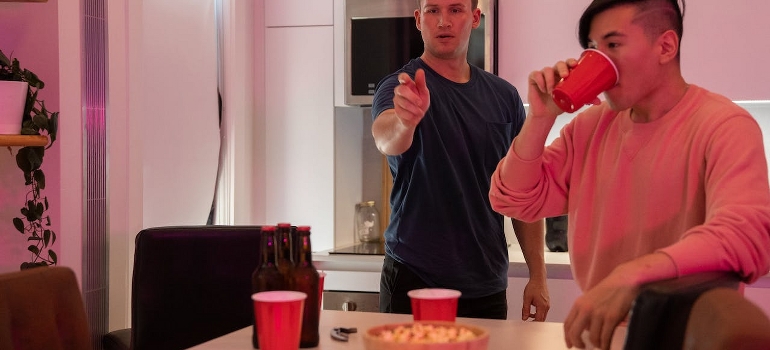 Men play Mocktail Pong, which is one of the non-alcoholic drinking games.