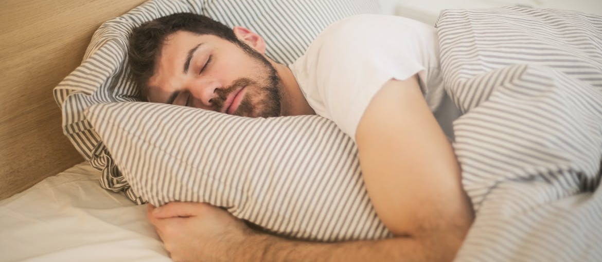 Man sleeping in his bed.
