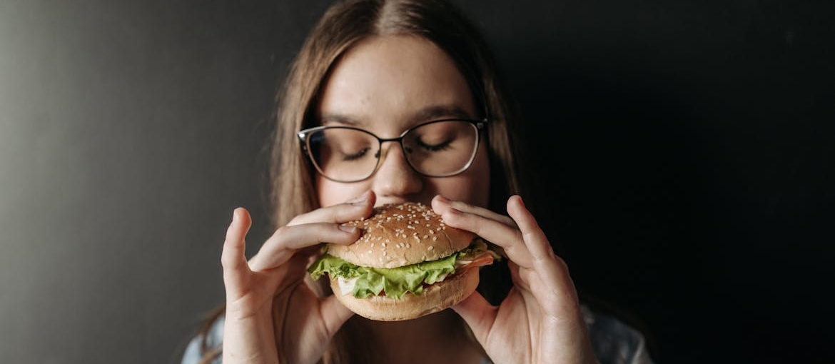 Woman eating a burger.