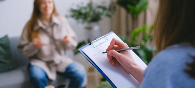 A woman talking to a therapist about the effects of drug abuse on fertility