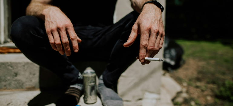 a man smoking and drinking