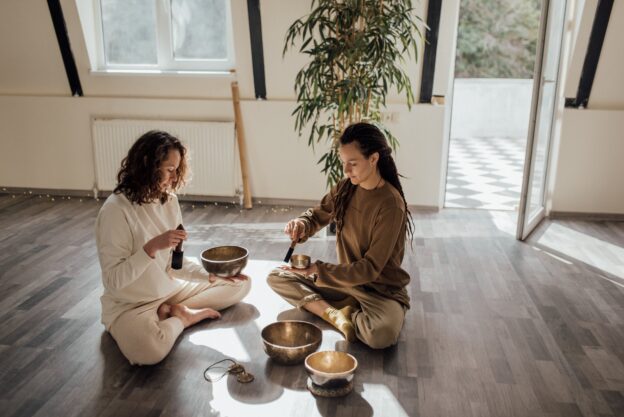 Two people in sound bath therapy talking about hobbies to explore at rehab