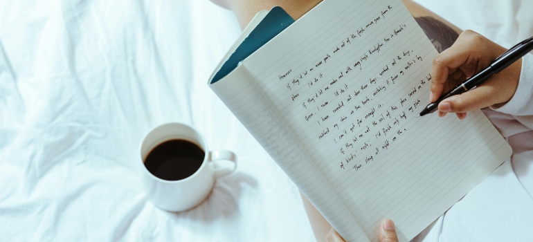 A person writing in a notebook