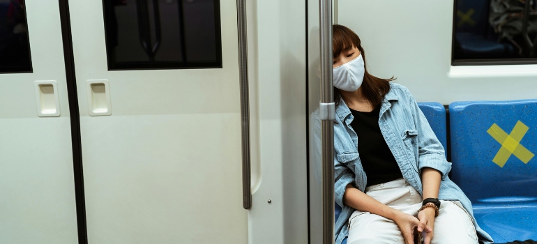 A woman sleeping in a train after combining prescription drugs and alcohol