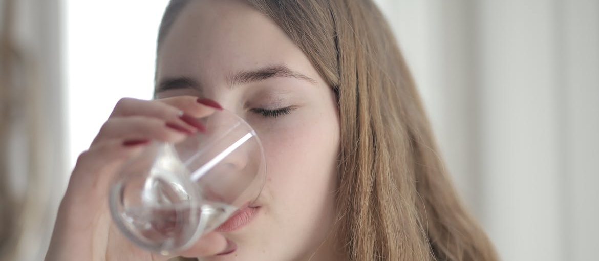 Woman drinking a glass of water.
