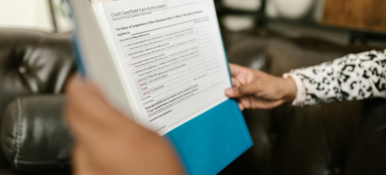 A person holding documents about Court Ordered Rehab in WV
