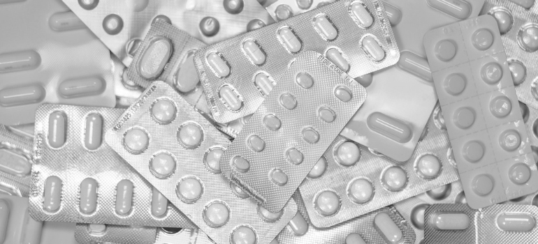 Some white pills in their container