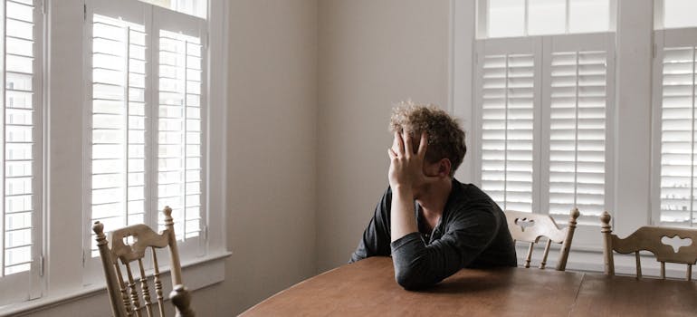 Man sitting at the table and suffering from addiction among first responders.