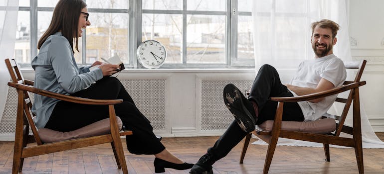 Man talking to his therapist and laughing.
