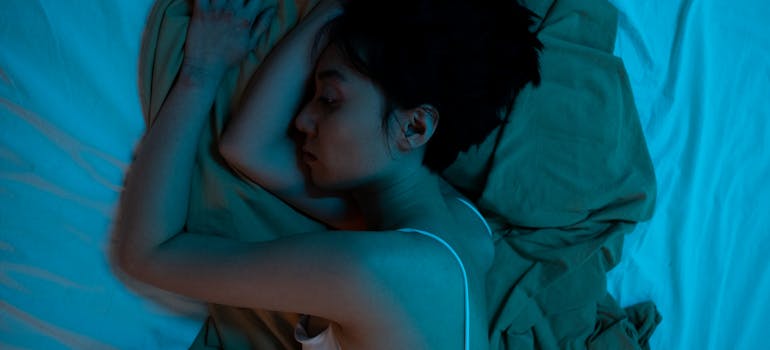 Woman experiencing insomnia, one of the dangers of benzodiazepine misuse.