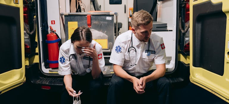 Paramedics sitting at the back of the ambulance.