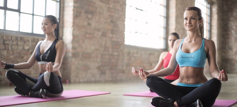 Woman doing yoga as a part of holistic treatment in a professional rehab center.