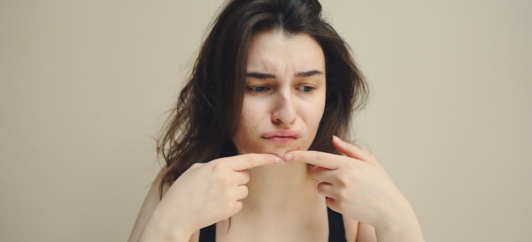 woman picking her skin.