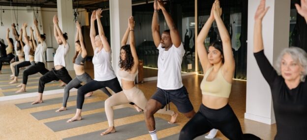 People doing pose in yoga class activities and hobbies