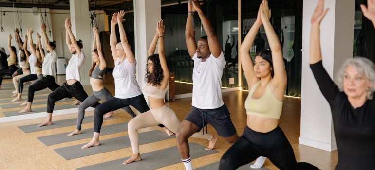 People doing pose in yoga class activities and hobbies