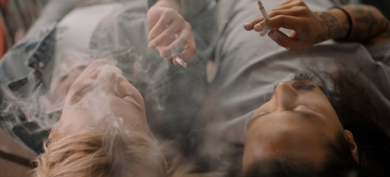 Two people smoking cigarettes