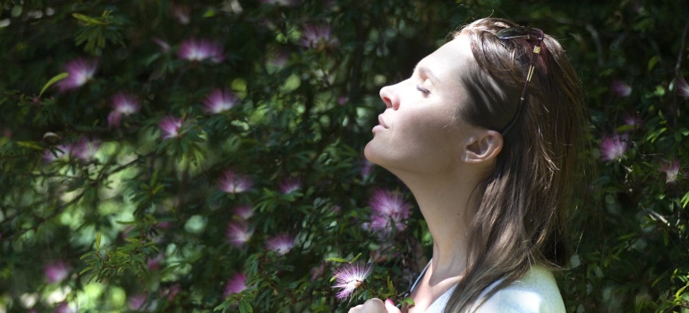A woman with her eyes closed breathing