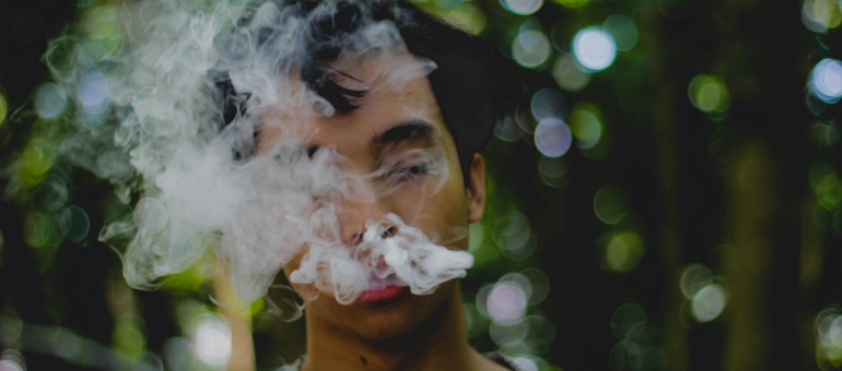 A guy exaling smoke