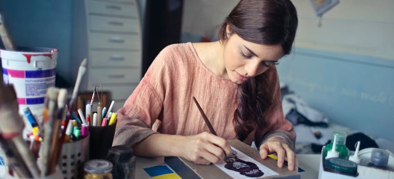 Woman painting as part of her art therapy.