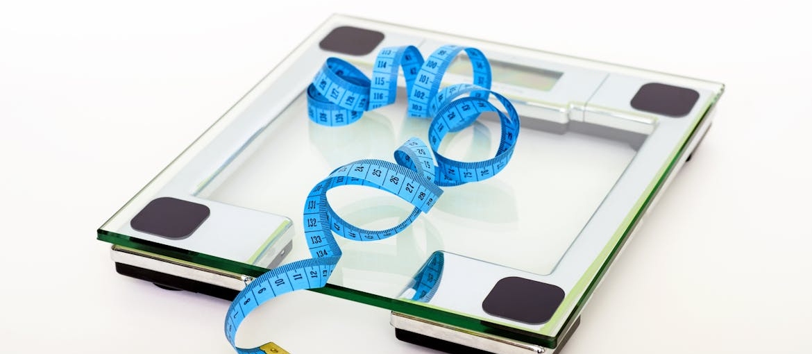 Measuring tape on a weight scale.