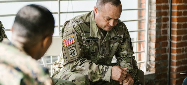Man attending peer support therapy with fellow veterans.