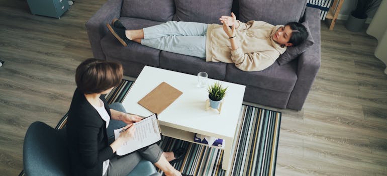 Woman lying on the couch talking to her therapist.