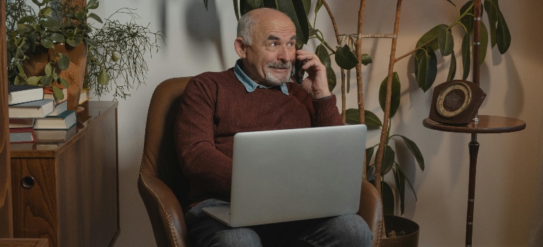 An elderly man talking on the phone about mental health support and addiction treatment for aging adults