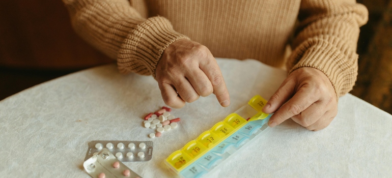 A person organizing their medicines