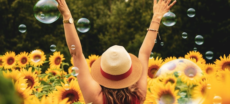 A woman surrounded by sunflowers symbolizing Preventing Relapse While Undergoing Treatment with Medications