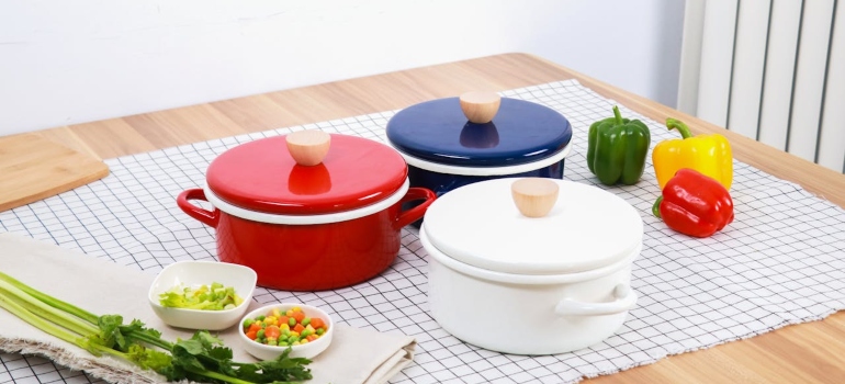 Food, vegetables, and pots on checked tablecloth