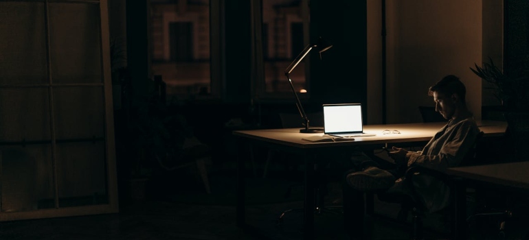 A silver MacBook on a wooden table