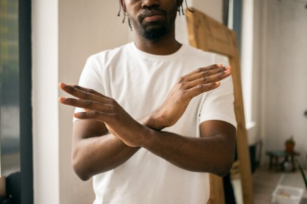 Man holding his arms in front of his chest.