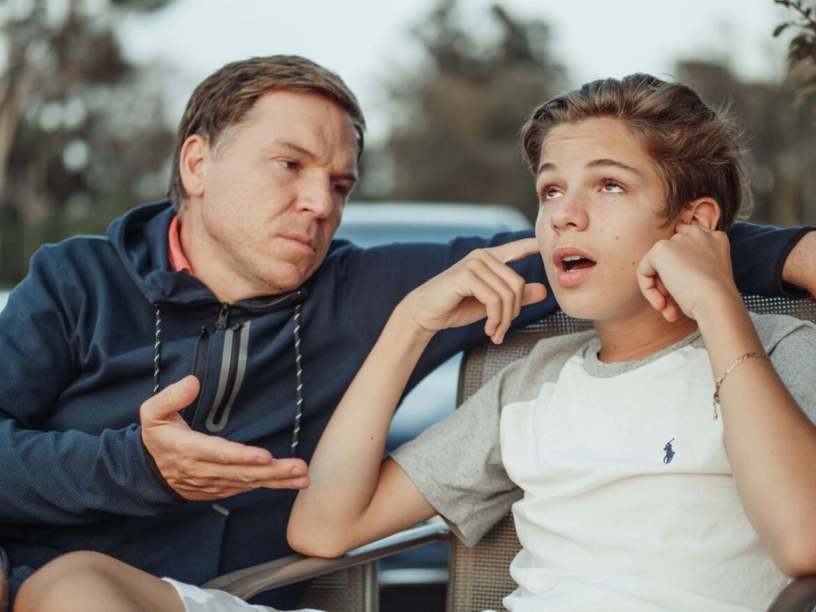 Father talking with teenage son about the warning signs of teen substance use.