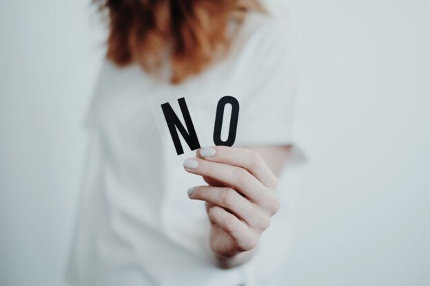 Woman holding the word no.