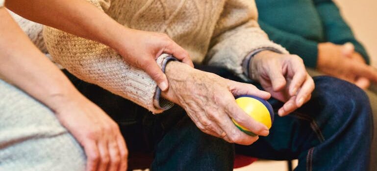 A picture of people holding hands in a therapy session where they are setting realistic goals for in addiction recovery in West Virginia.