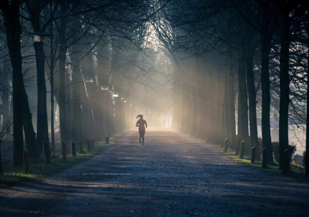 Woman running in the woods.