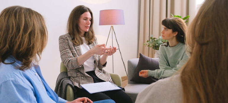 Mental female specialist speaking to the group of women