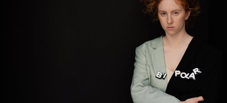 A woman standing in the black background