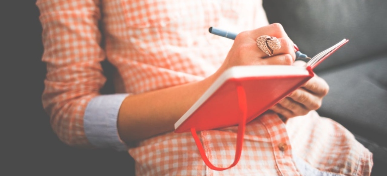 a woman writing in her journal