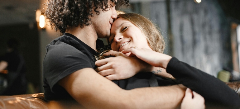 A man is hugging his girlfriend and giving her support.