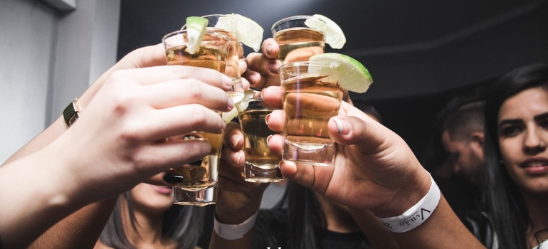 people toasting with tequila shots