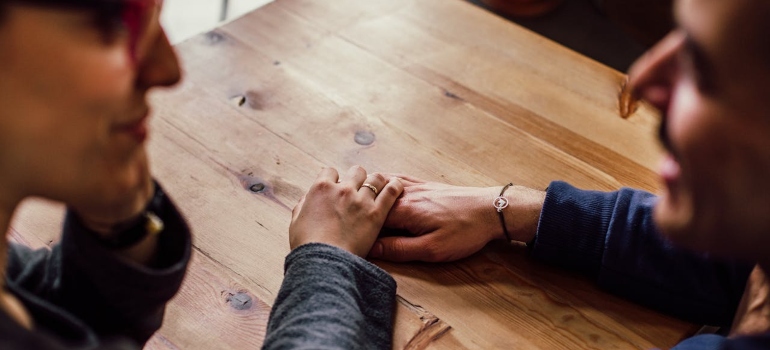 a couple talking and holding hands