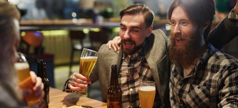 men drinking beer in a bar
