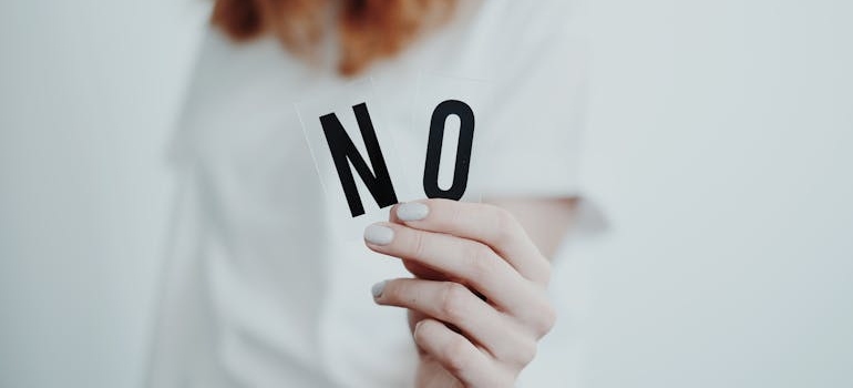 Woman holding a word no in her hands.