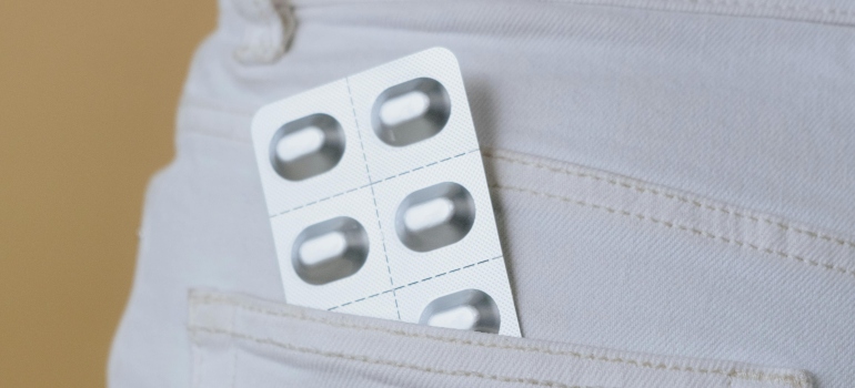 A person has put pills in the back pocket.