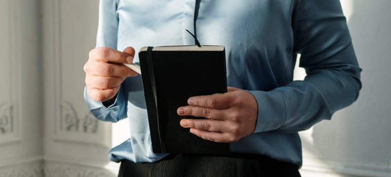 a woman holding a notes
