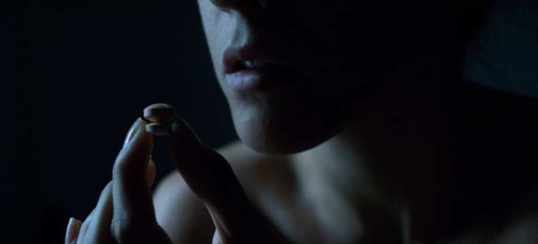 a girl holding some pills and experiencing setbacks in recovery