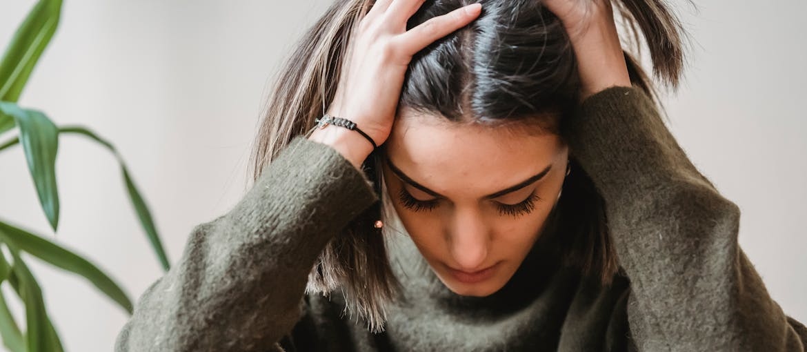 Woman experiencing a headache from fentanyl laced weed.