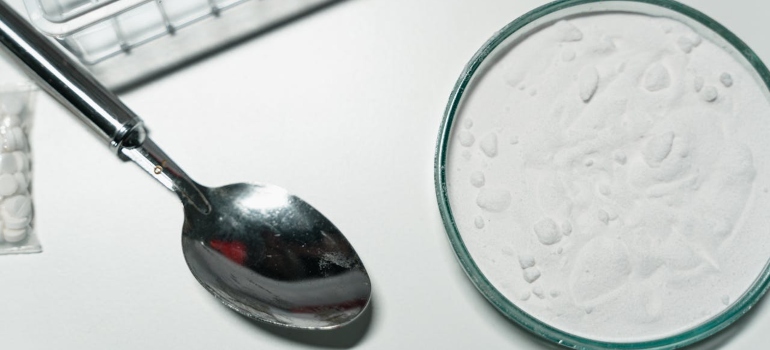 white powder in a bowl and a spoon next to it