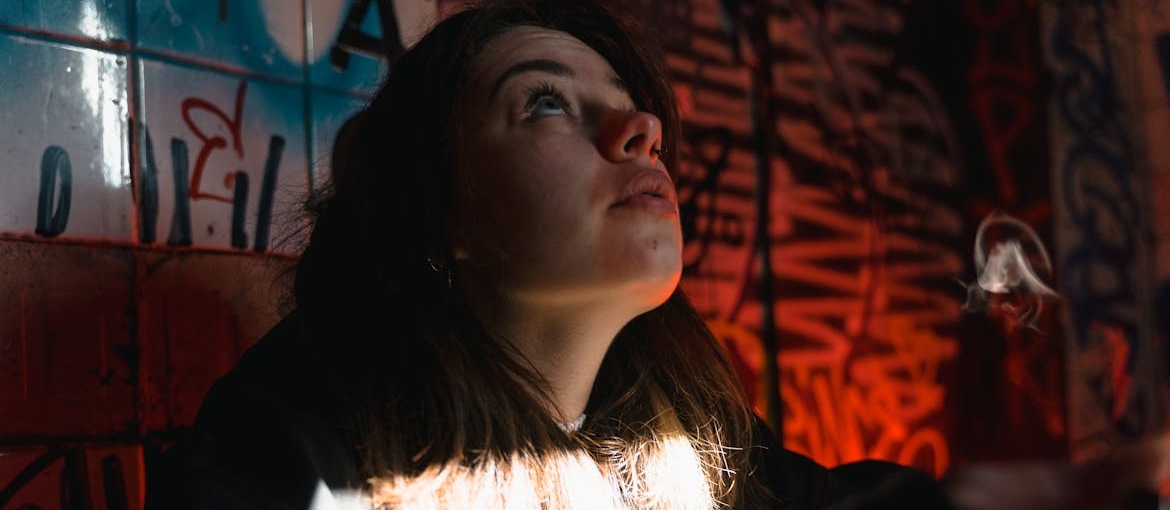 A woman is looking at a ceiling.